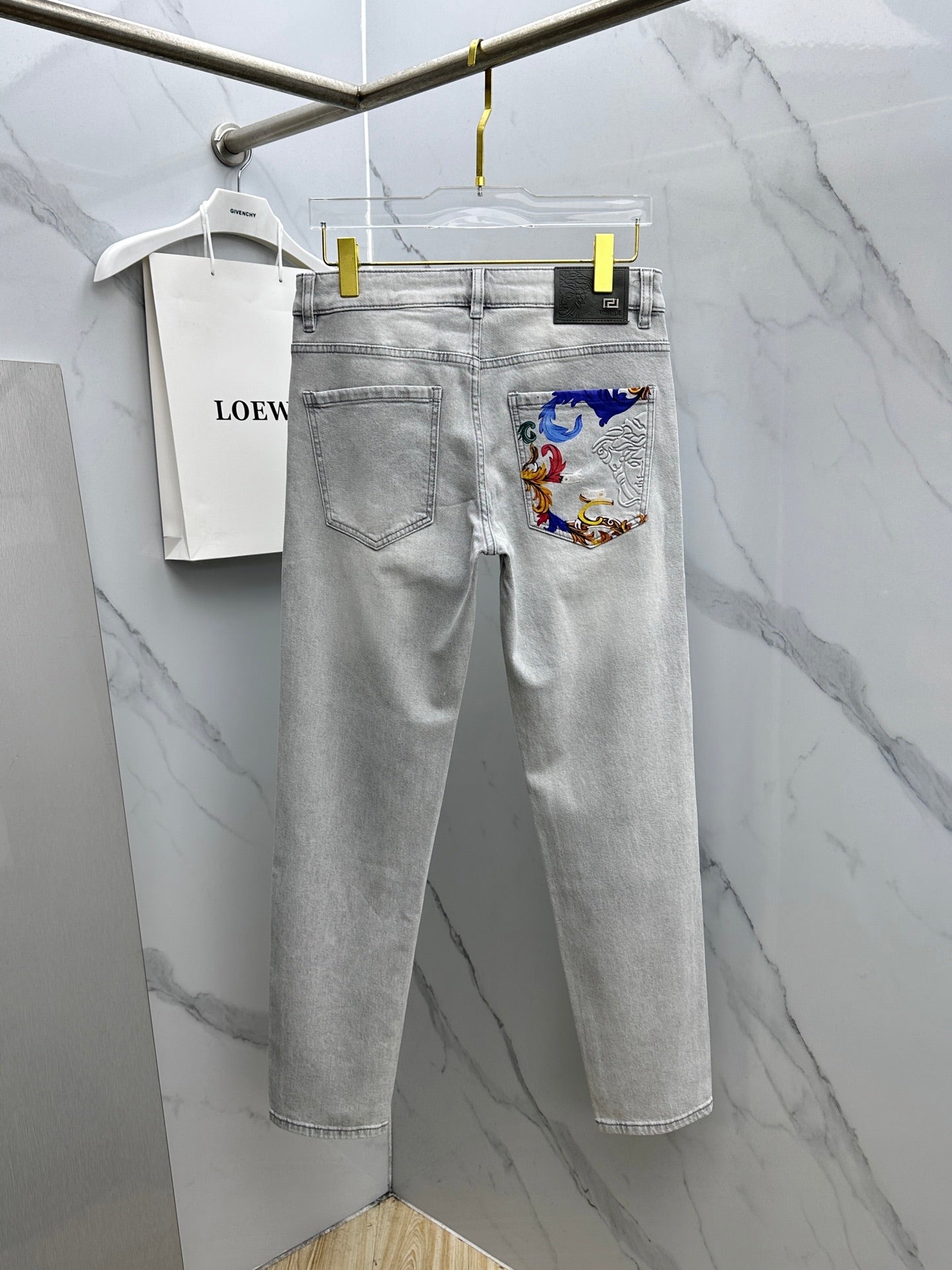 Light-wash jeans with embroidered front pocket detail and belt loops