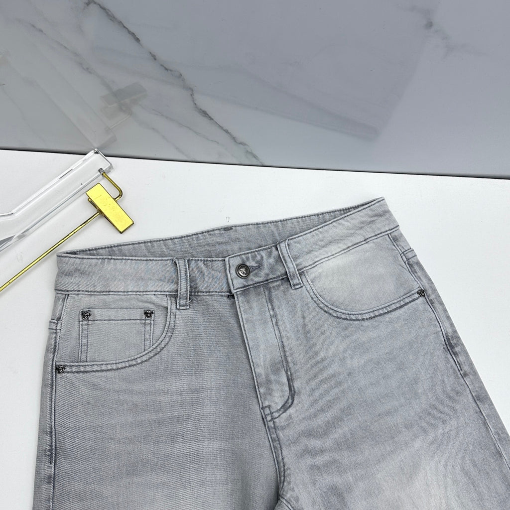 Light-wash jeans front with belt loops, button closure, and curved pocket
