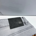 Light-wash jeans with embossed black leather logo patch on waistband