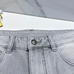 Light-wash jeans waistband with small metal logo patch