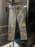 Light gray denim pants with colorful cross patches on the legs