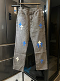 Light gray denim pants with blue cross patches, straight legs, button fly