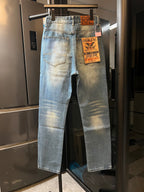 Light-wash denim jeans with faded finish, front patch pockets and hanging tags