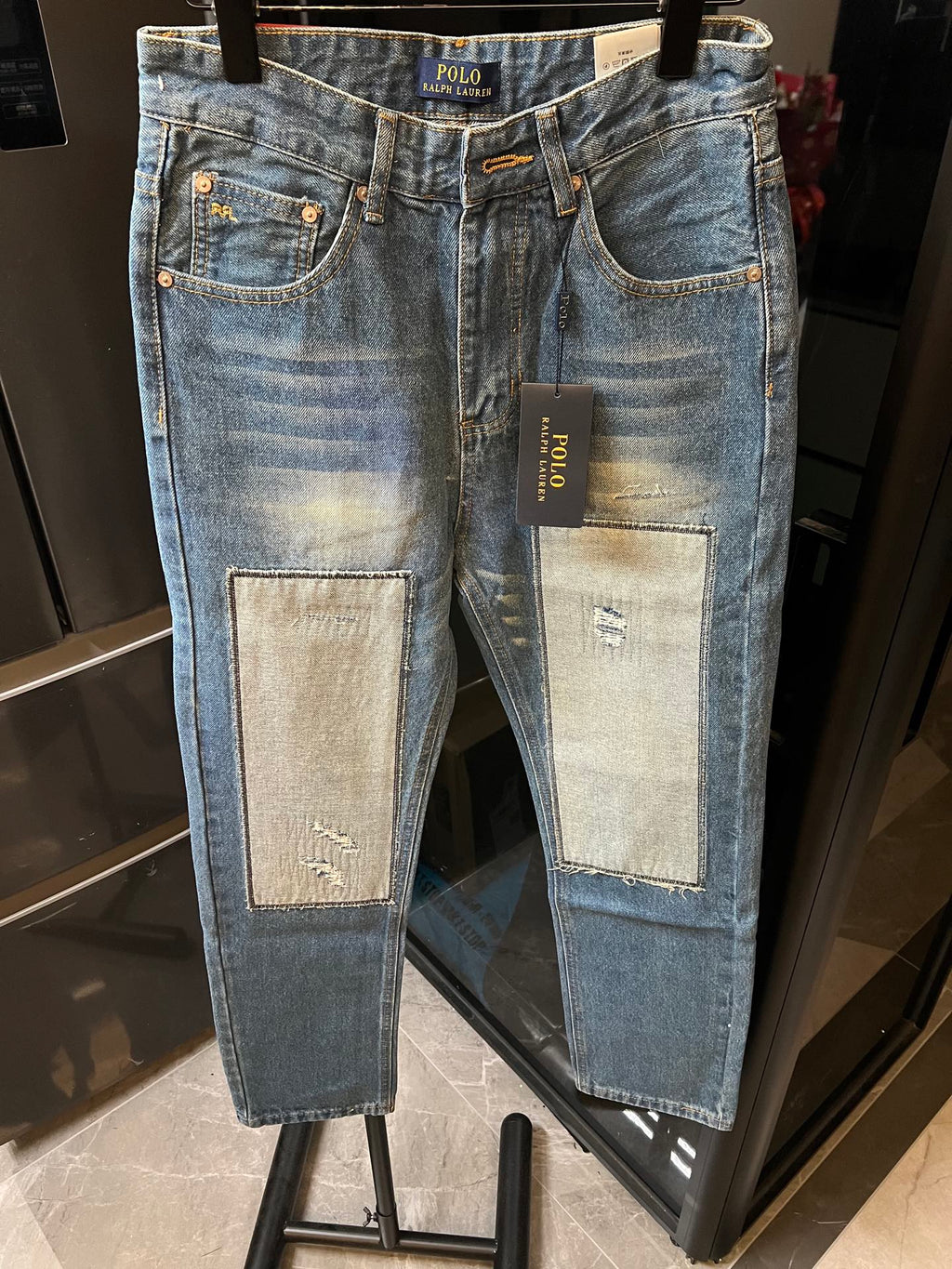 Light blue denim jeans with logo waistband and two front patch pockets