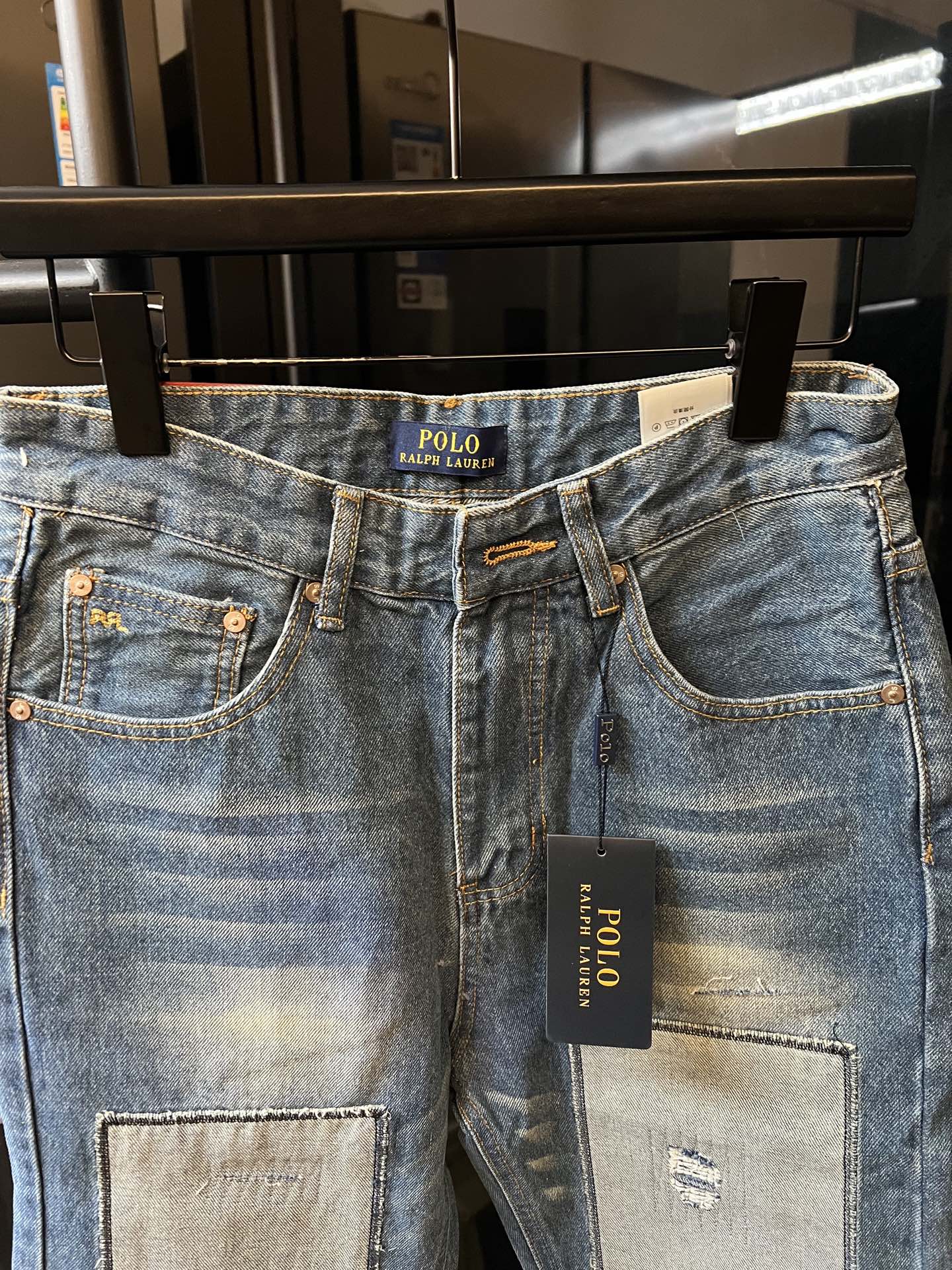 Light blue denim jeans with button fly and front patch pocket