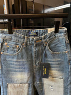 Light-wash denim jeans with belt loops and front patch pocket panels