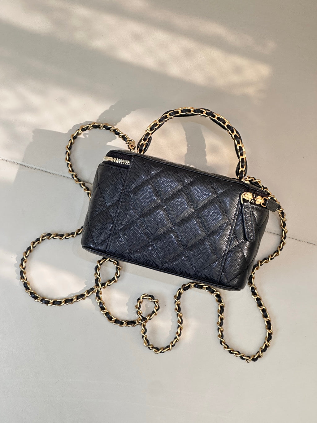 Chanel quilted mini bag in dark navy with gold chain and front zipper detail