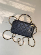 Chanel quilted mini bag in dark navy with gold chain and front zipper detail