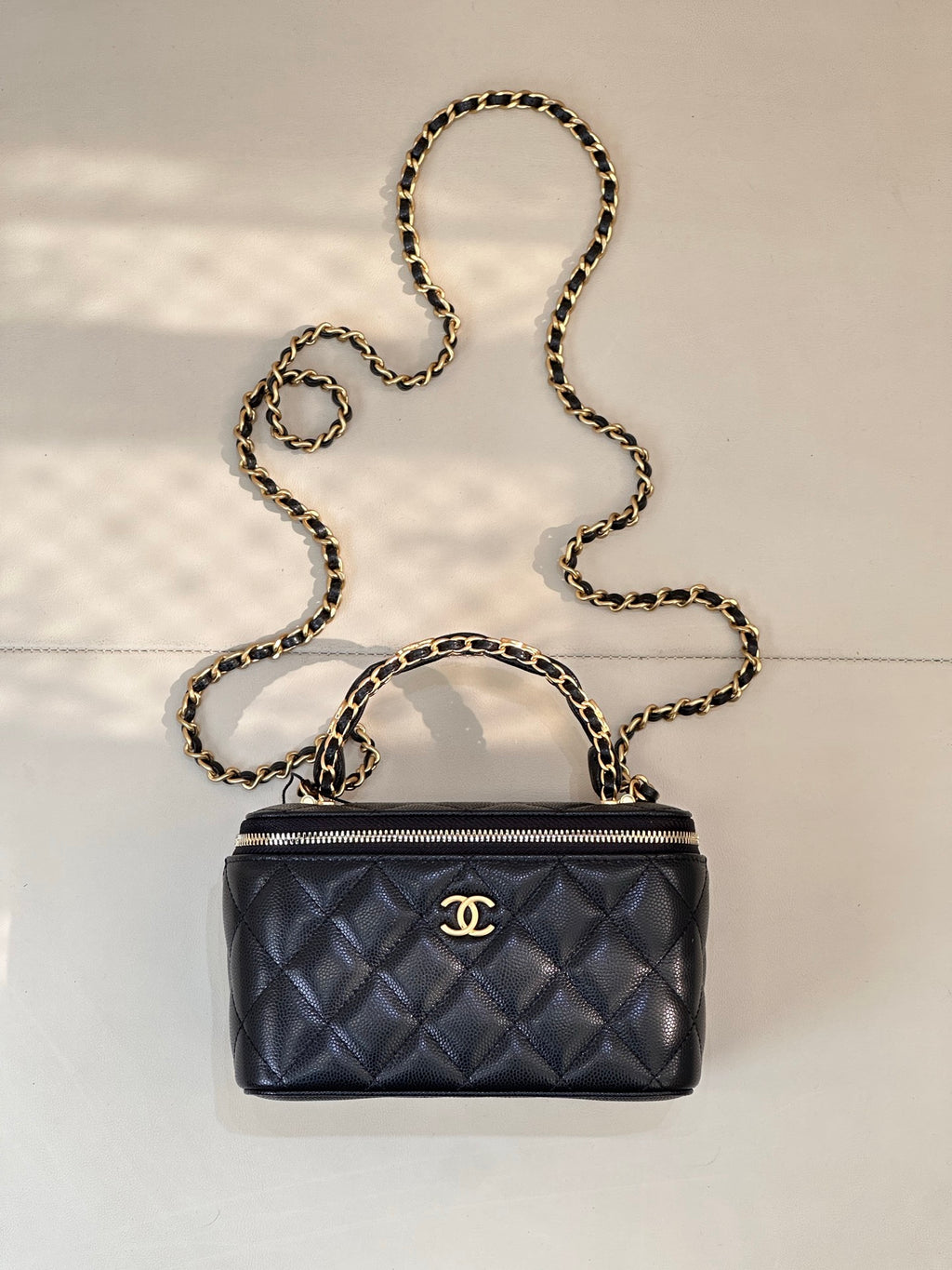 Chanel quilted mini bag in dark navy with gold chain strap and zipper top