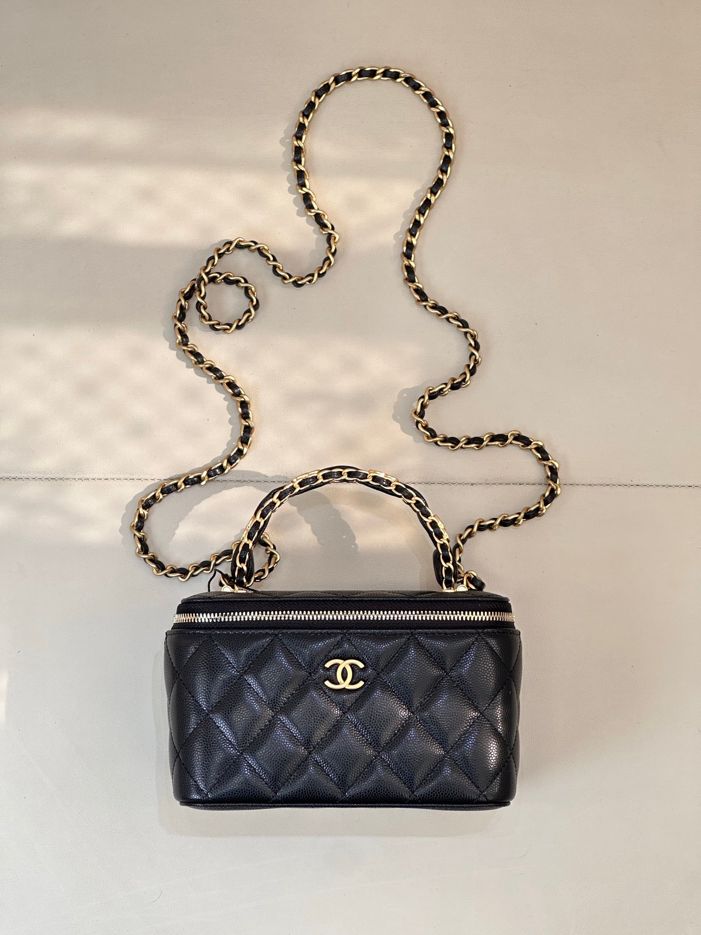 Chanel quilted mini bag in dark navy with gold chain strap and zipper top