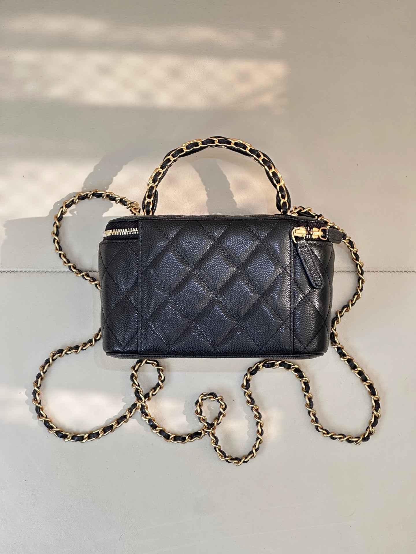 Chanel quilted mini bag in dark navy with gold chain shoulder strap