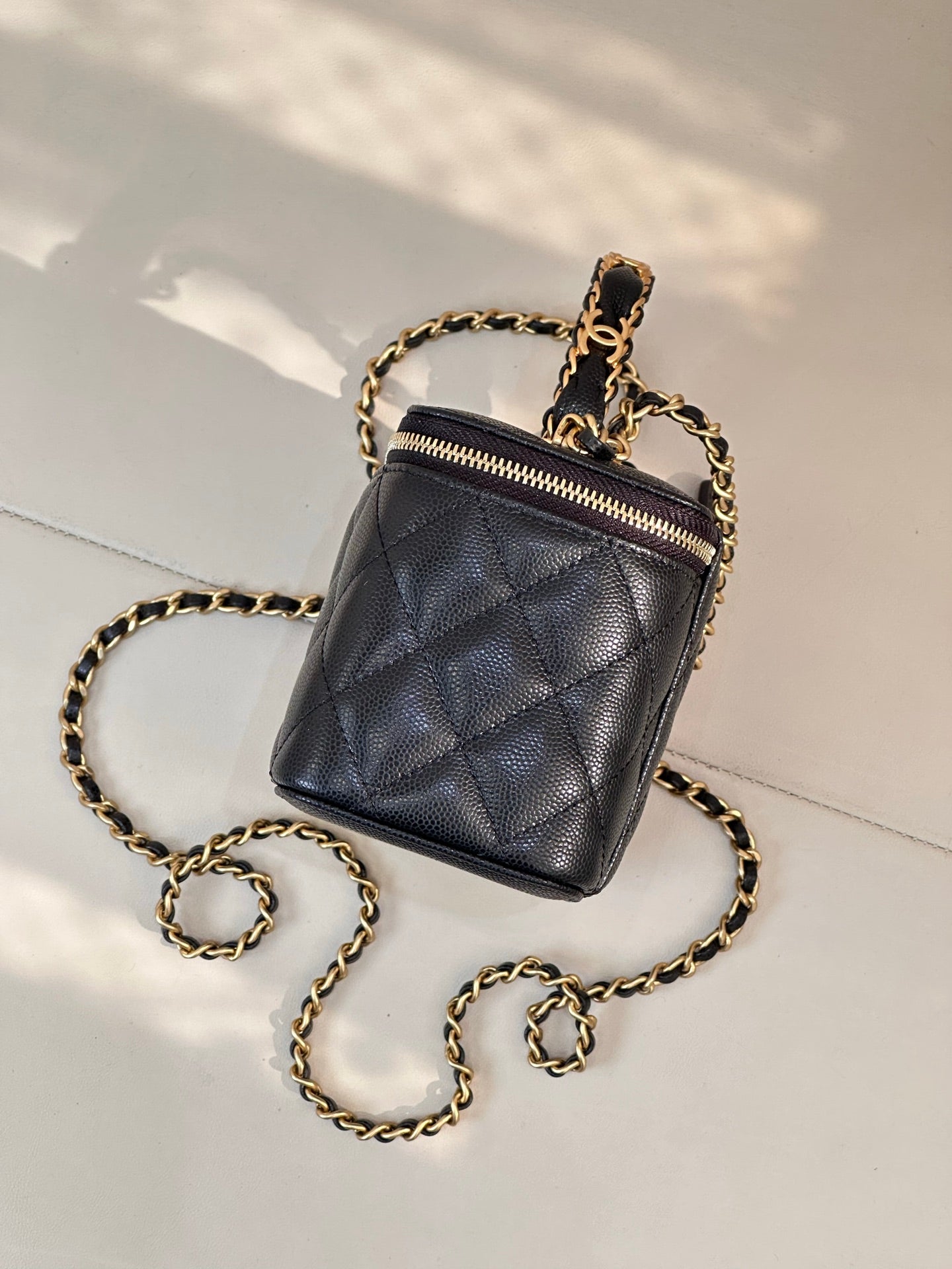 Chanel quilted mini bag in dark navy with gold chain strap and front zipper