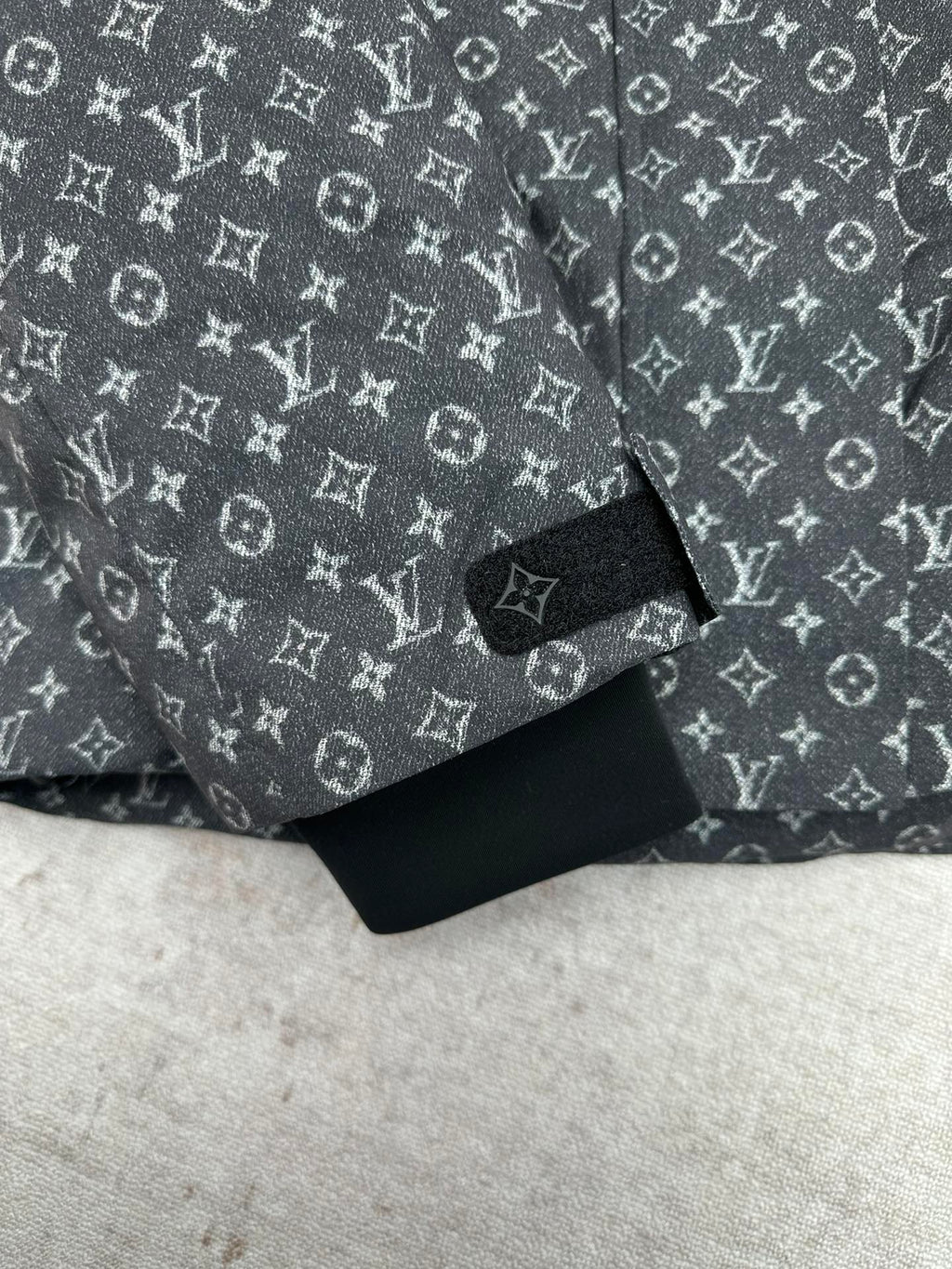 Louis Vuitton monogram puffer jacket sleeve cuff and hem, dark gray and black.