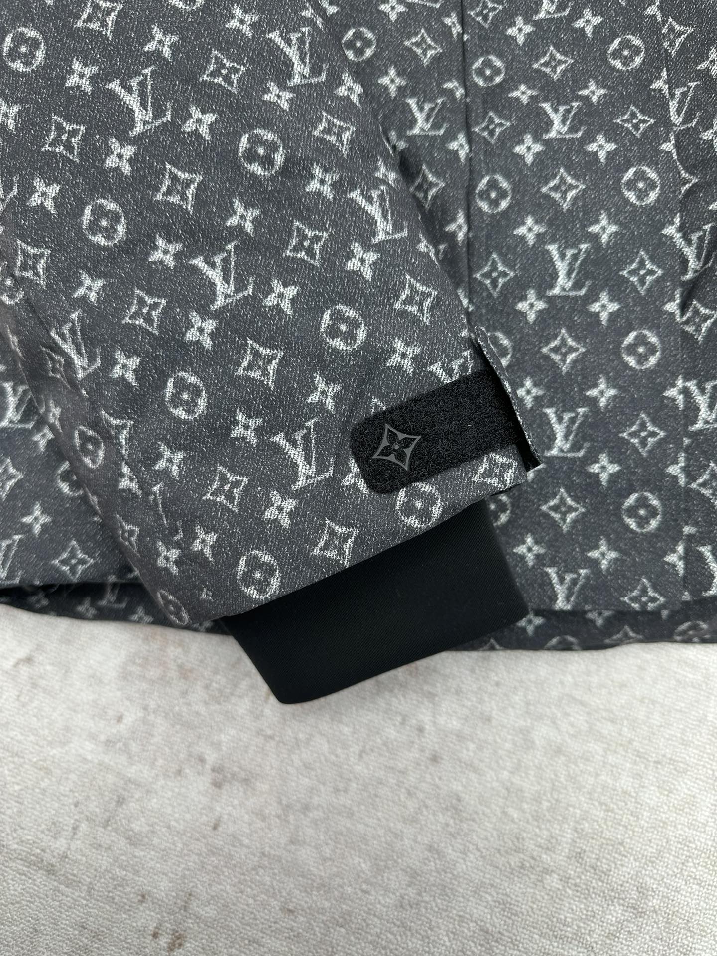 Louis Vuitton monogram puffer jacket sleeve cuff and hem, dark gray and black.