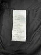 Polyester and elastane care label inside dark Louis Vuitton puffer jacket.
