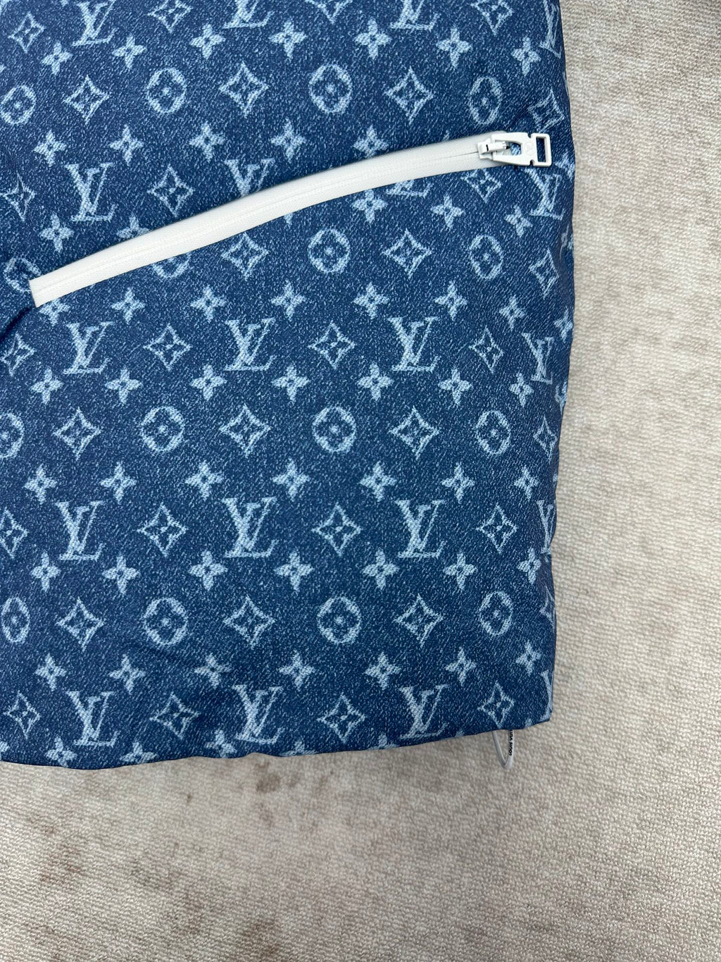 Blue Louis Vuitton monogram jacket with white zip trim along side seam