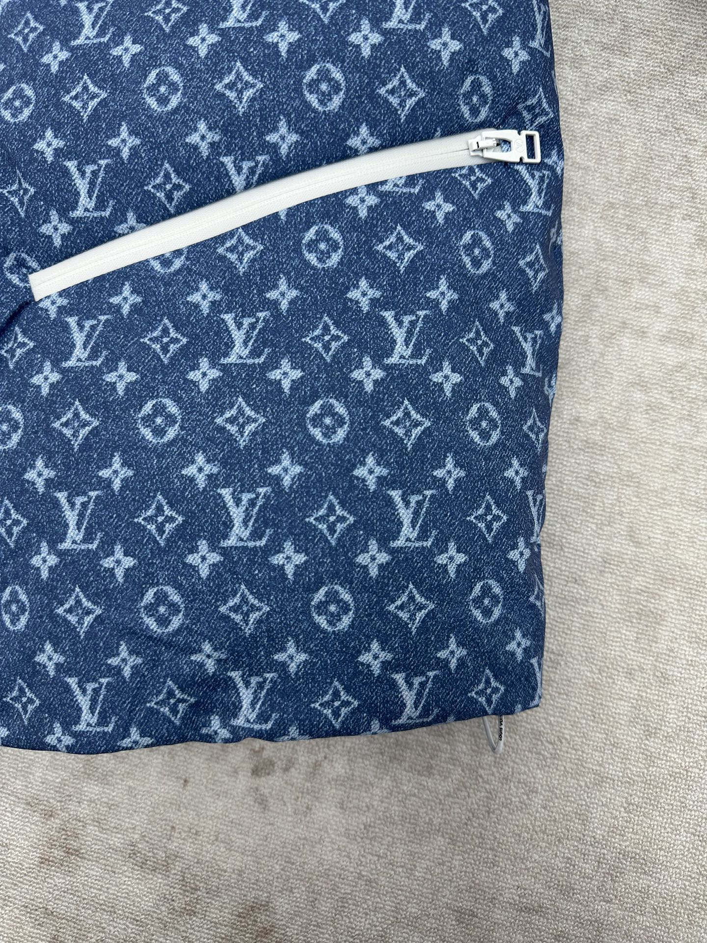 Blue Louis Vuitton monogram jacket with white zip trim along side seam