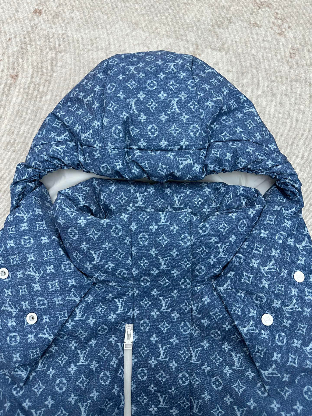 Blue hooded jacket with white Louis Vuitton monogram pattern, hood detail and inner pouch