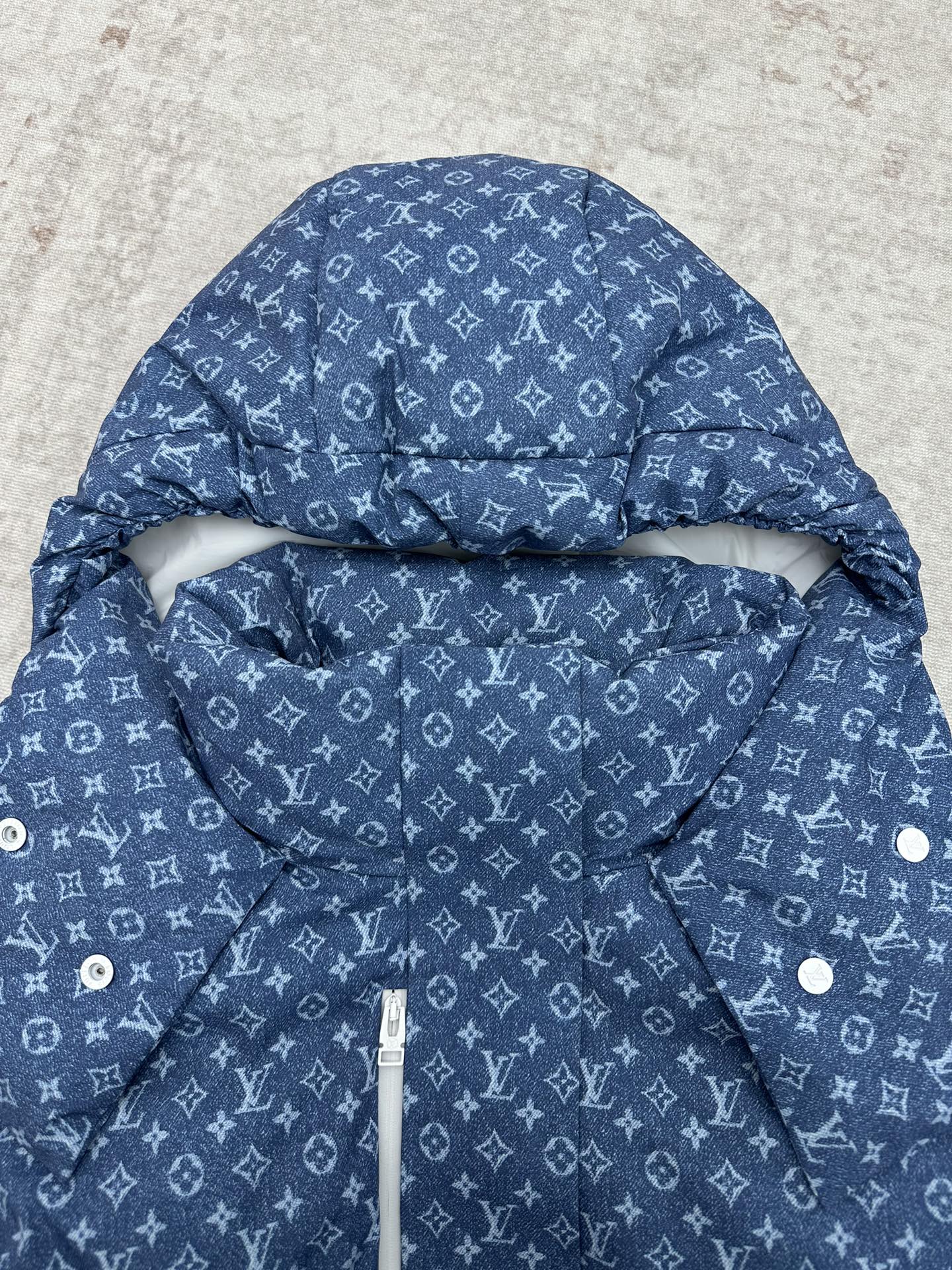 Blue hooded jacket with white Louis Vuitton monogram pattern, hood detail and inner pouch