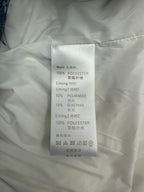 White garment label listing 100% polyester shell and lining, with elastane and polyamide