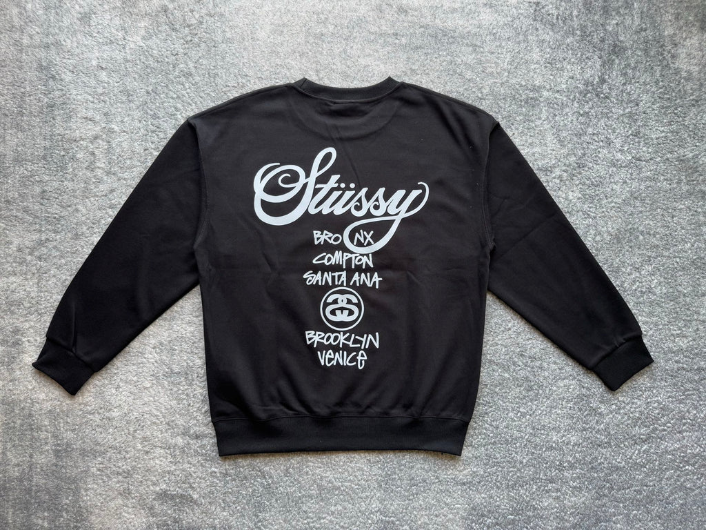 Stussy crewneck sweatshirt, dark with white logo and city list on back