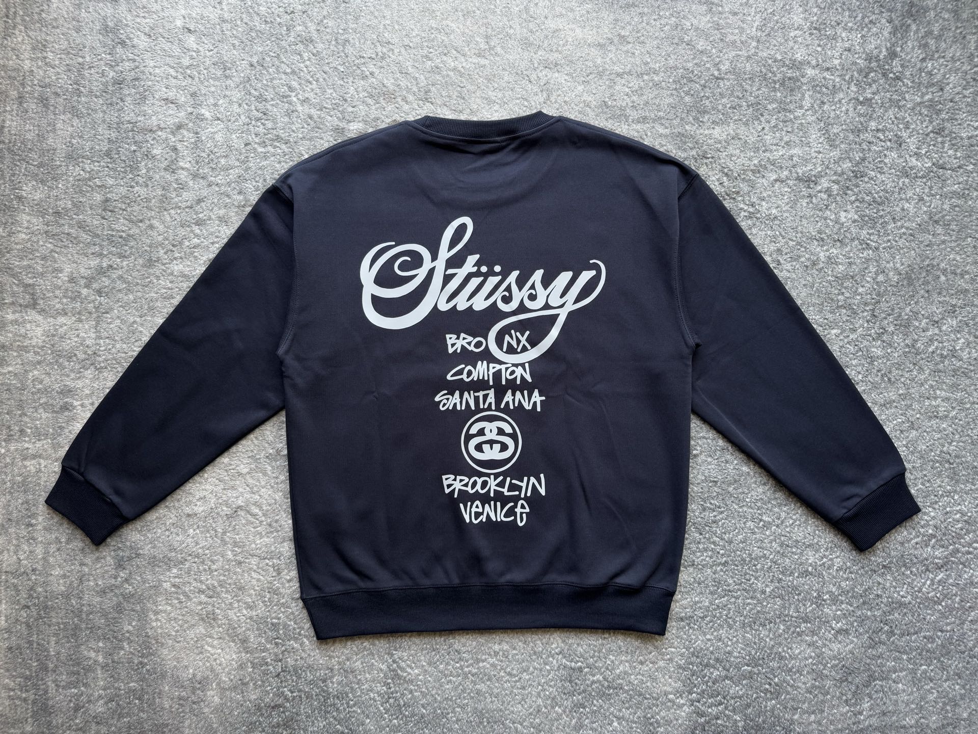 Stussy crewneck sweatshirt, dark with white back graphic and circular logo