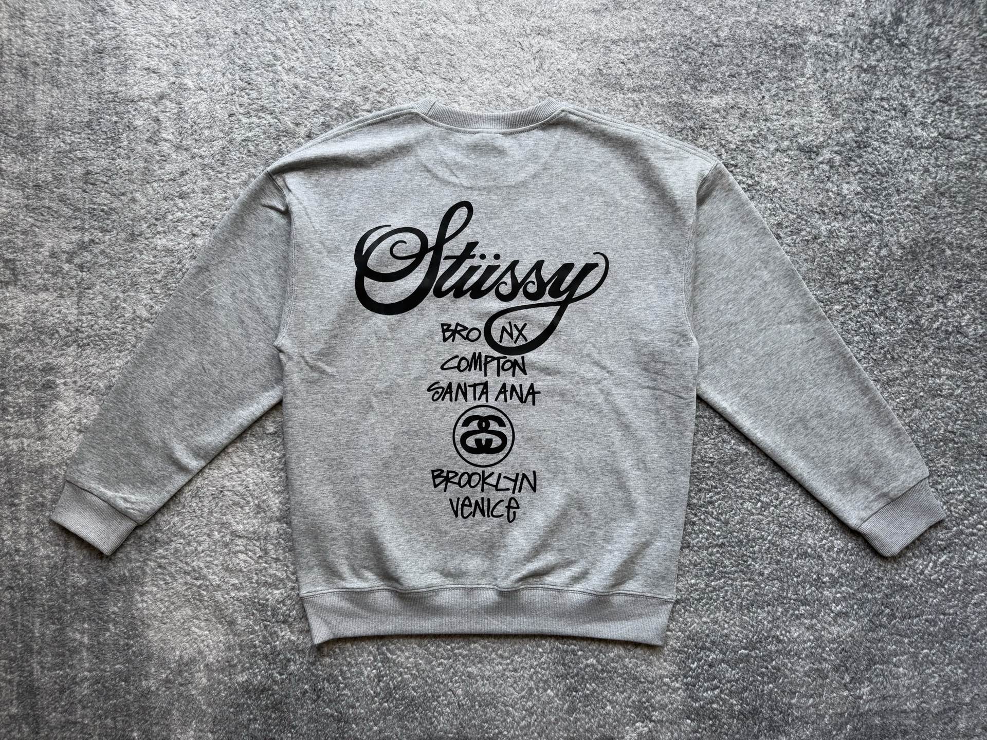 Stussy crewneck sweatshirt, light gray with white back logo and city text