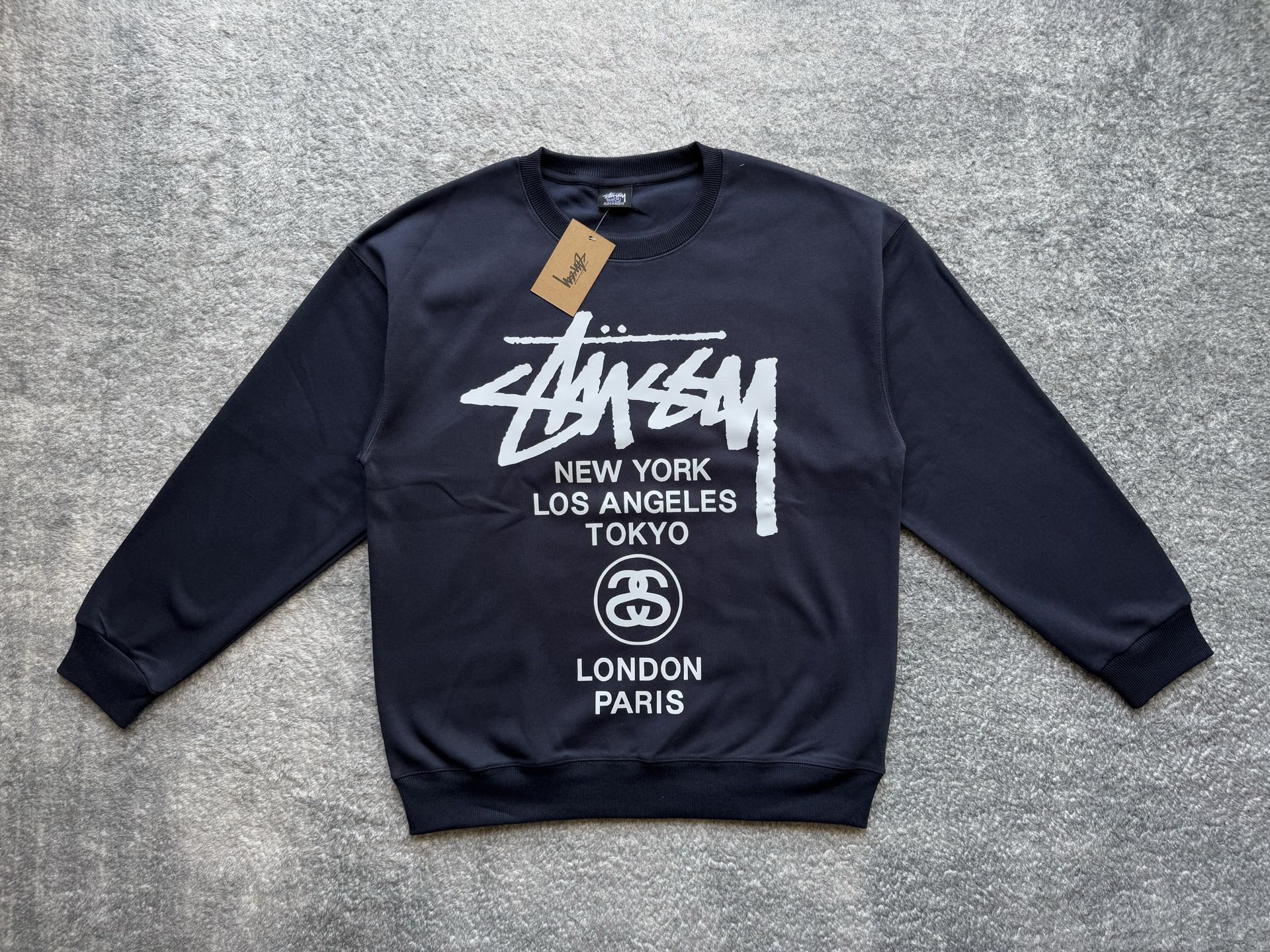 Stussy crewneck sweatshirt, dark with white front graphic and circular logo
