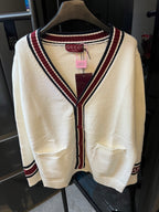 Cream Gucci knit cardigan front with V-neck stripes, button placket, patch pockets