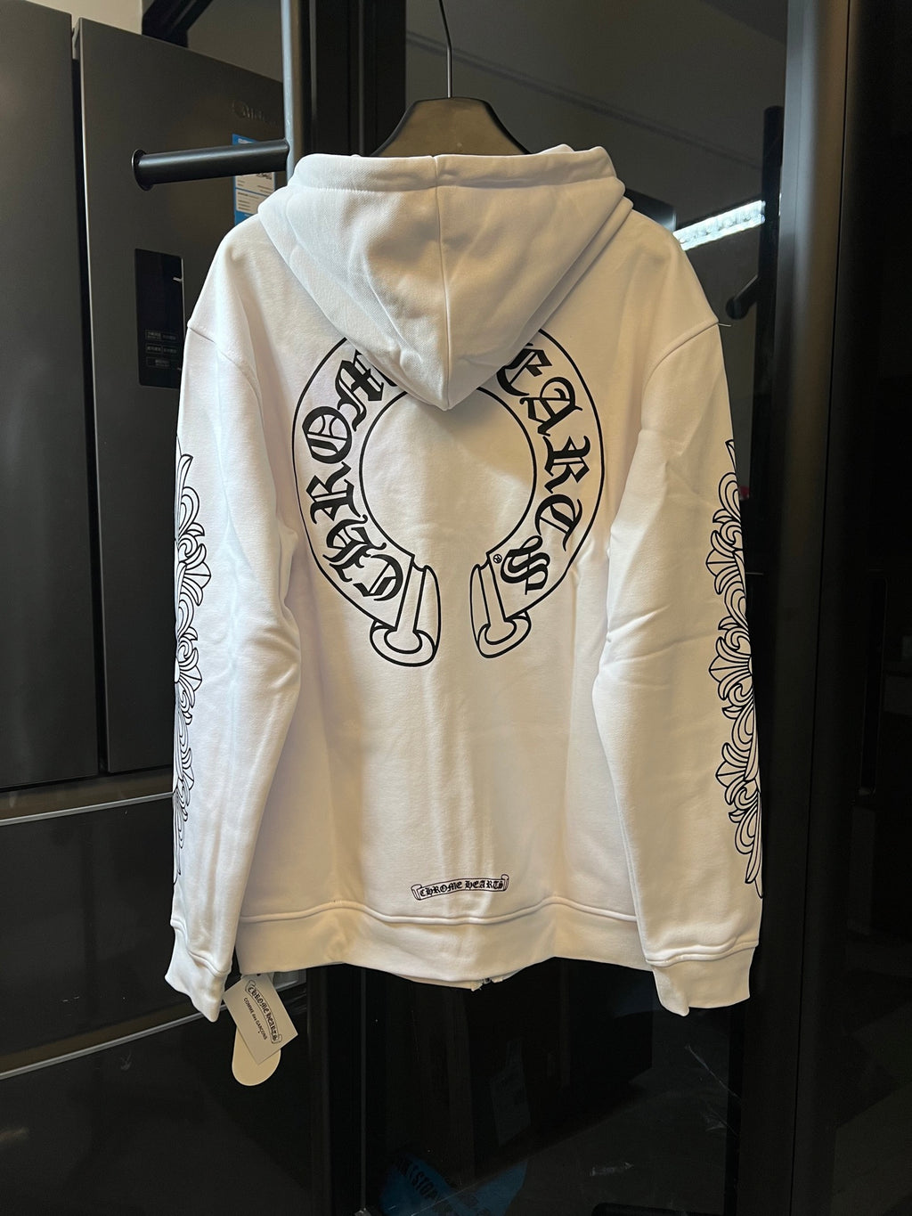 Light cream zip-up hoodie with hood and large back graphic print.