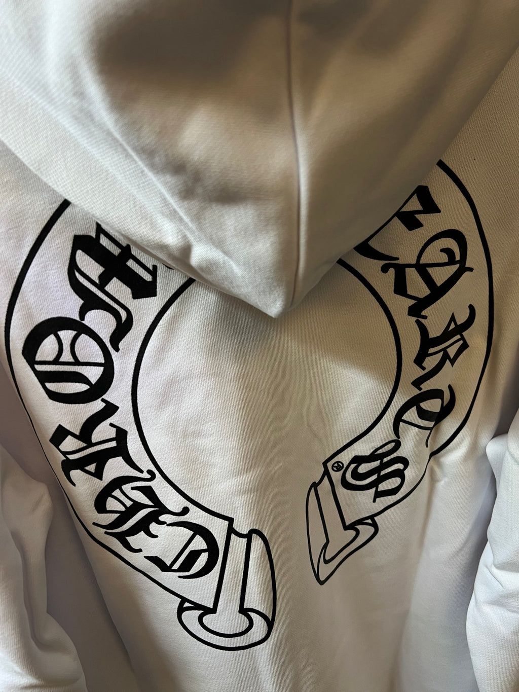Light cream hoodie front with large black graphic print.