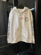 Light cream zip-up hoodie with hood, drawstring, and circular chest logo patch.
