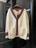 Cream Gucci knit cardigan with V-neck, red/blue stripe trim, front buttons, patch pockets