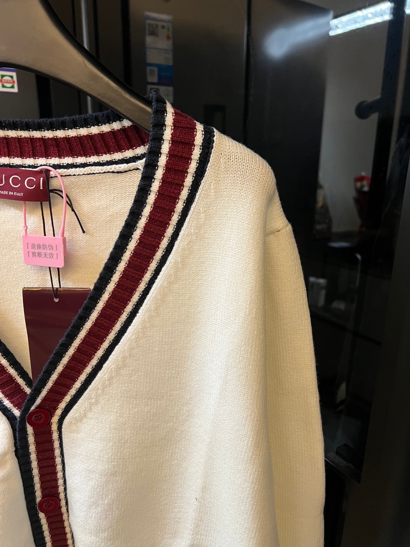 Cream Gucci knit cardigan with striped trim along side seam and shoulder