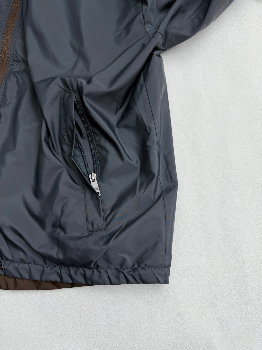 Prada hooded long jacket, blue-gray, front zip and pocket panel close-up
