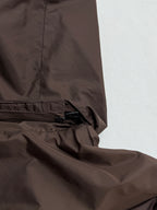 Brown jacket hem with elastic drawcord and zipper trim