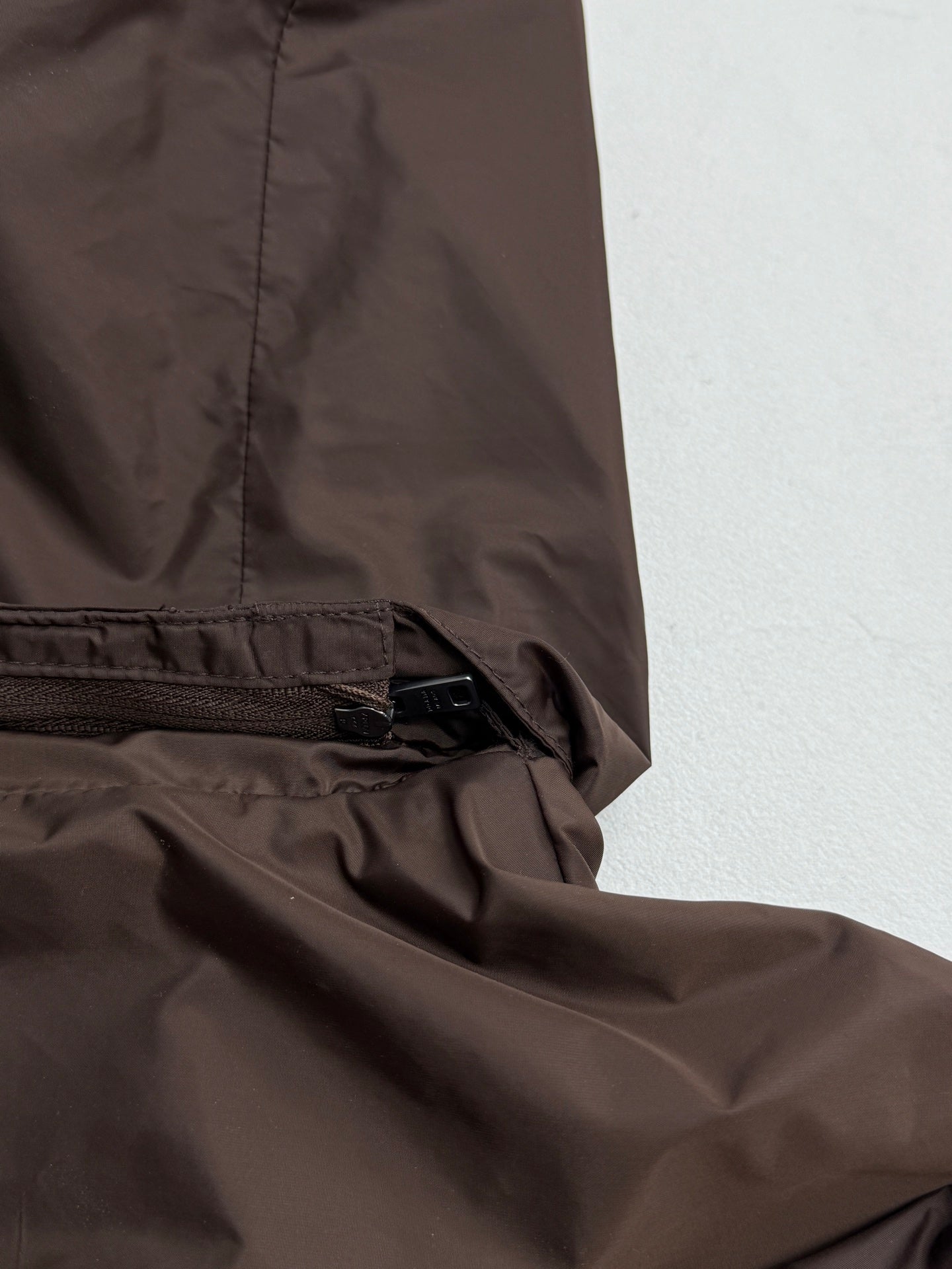 Brown jacket hem with elastic drawcord and zipper trim