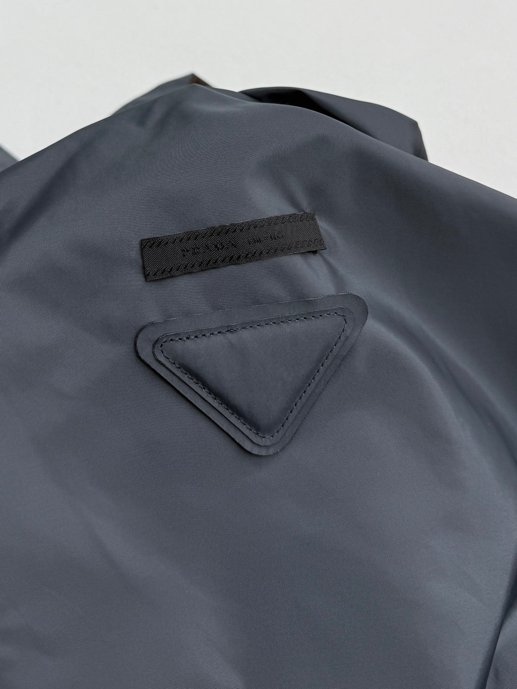 Prada hooded long jacket, blue-gray, chest logo patch and triangular trim