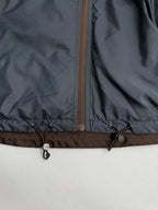 Prada hooded long jacket, blue-gray, hem drawstring toggles and zipper close-up