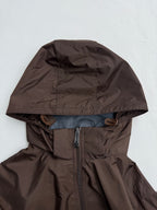 Long hooded jacket with full front zipper, brown shell and blue lining at hem