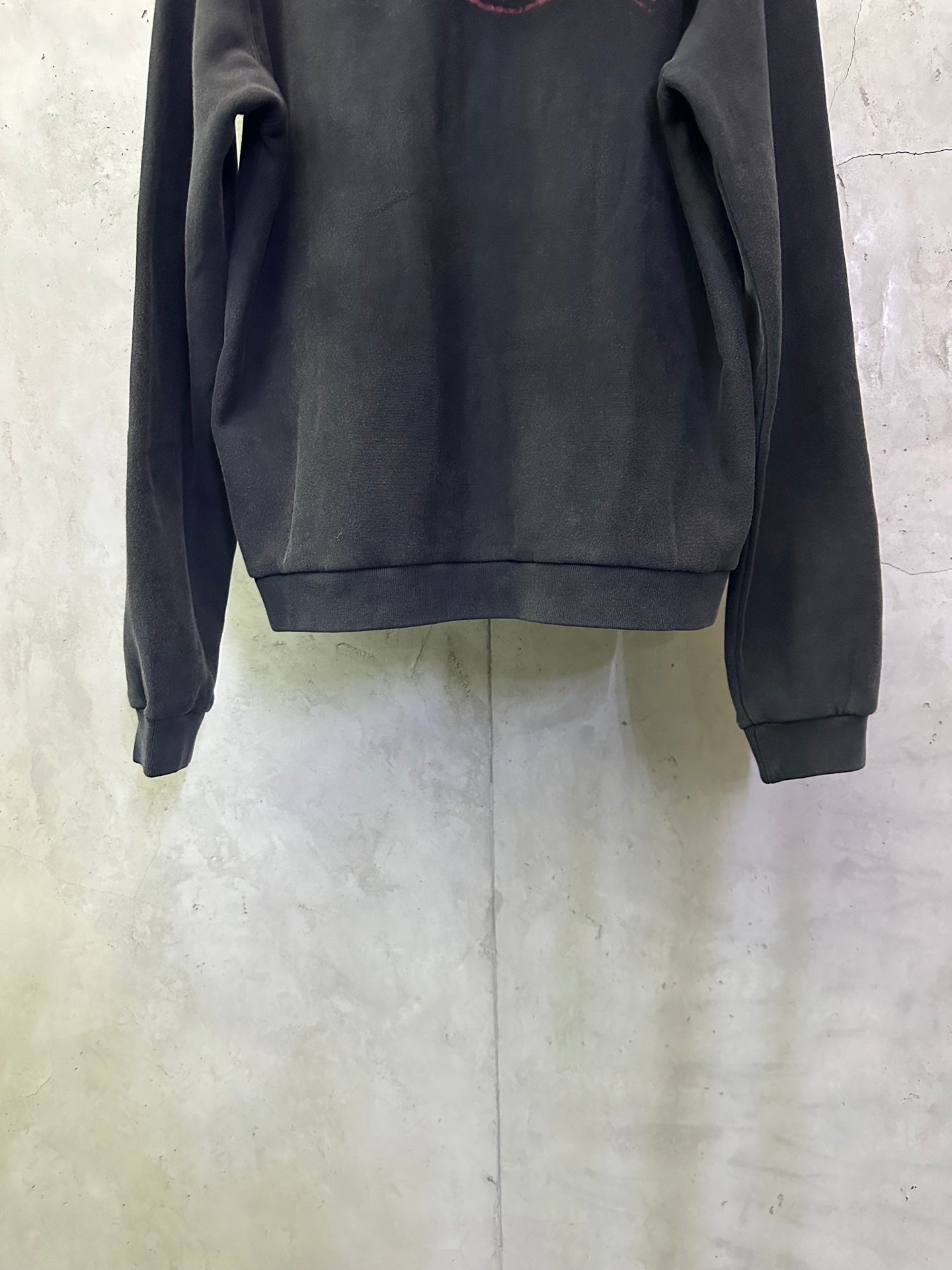 Dark hoodie with long sleeves and ribbed cuffs