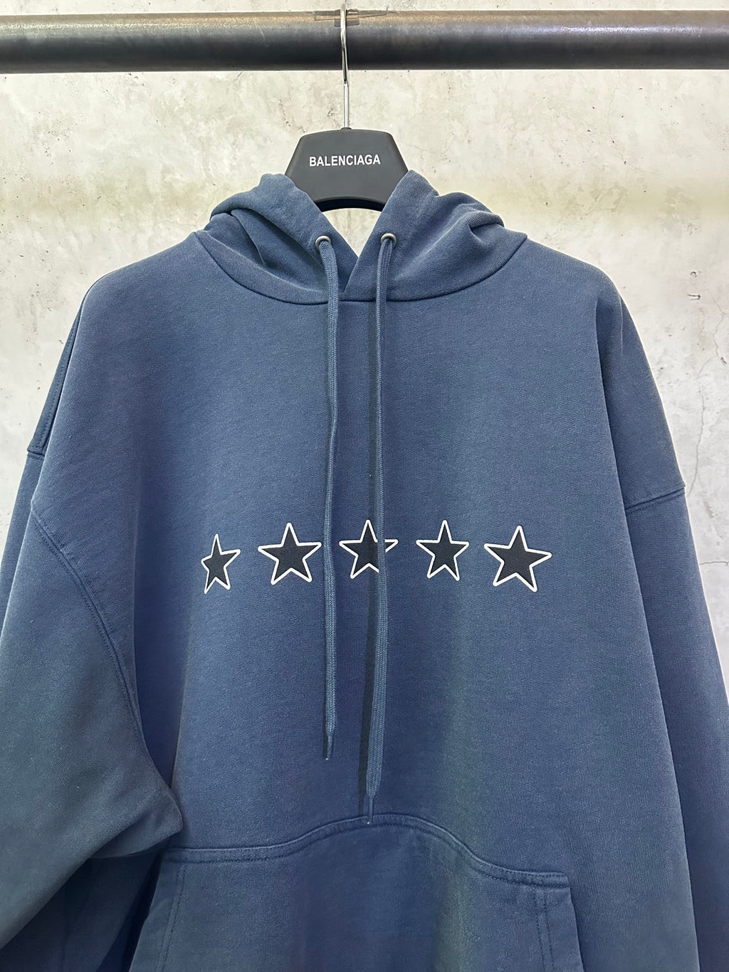 Balenciaga long hoodie close-up: blue with star and lightning logo on the chest