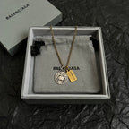 Gold chain necklace with circular silver charm and gold Cancer tag in gift box