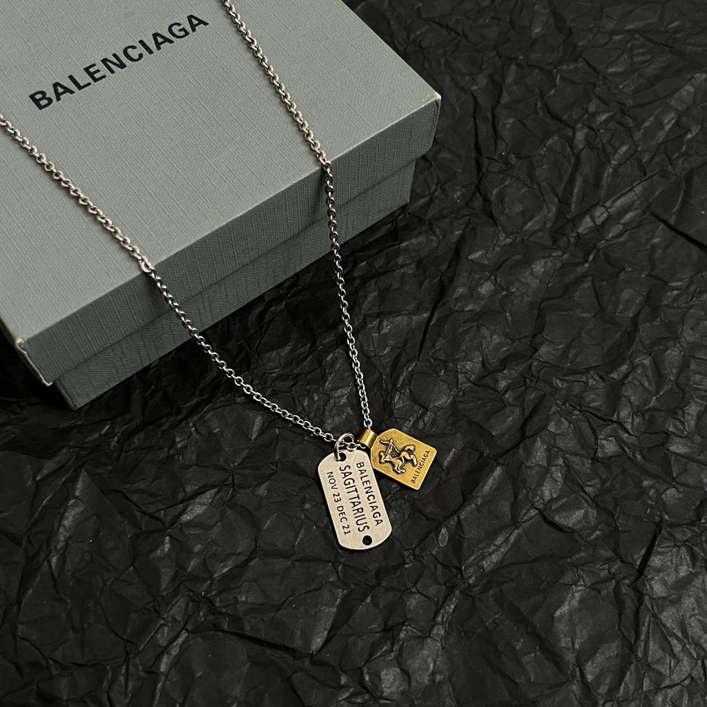 Silver-tone charm necklace with round tag and horse emblem pendants