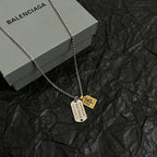 Silver-tone charm necklace with round tag and horse emblem pendants