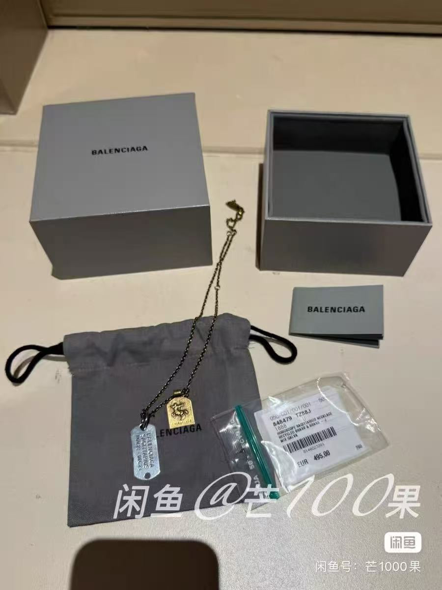 Charm necklace with dog-tag pendant, shown with gift box and pouch