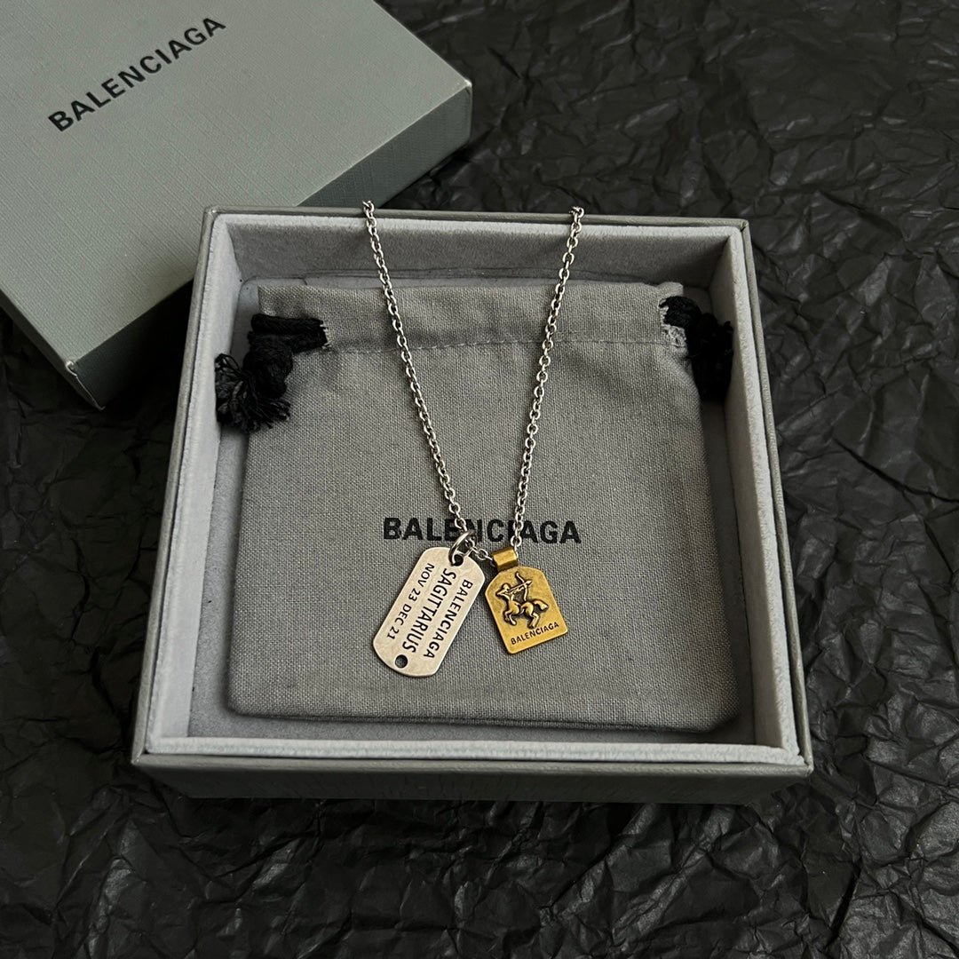 Balenciaga charm necklace with dog tag and small medallion pendants in silver tone