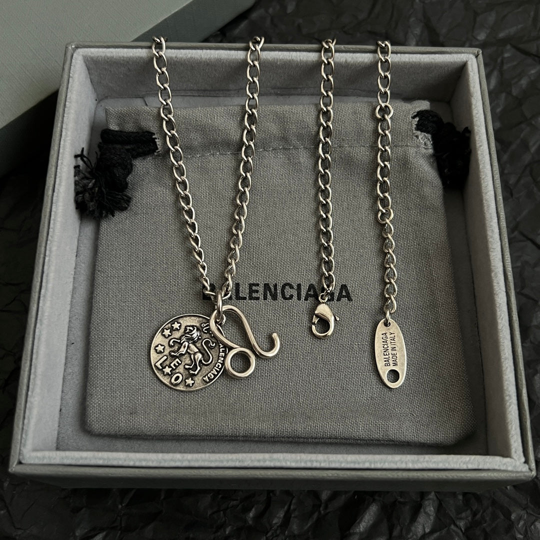 Balenciaga multi-charm necklace set with round logo pendants on silver chains