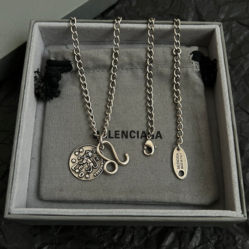 Balenciaga multi-charm necklace set with round logo pendants on silver chains
