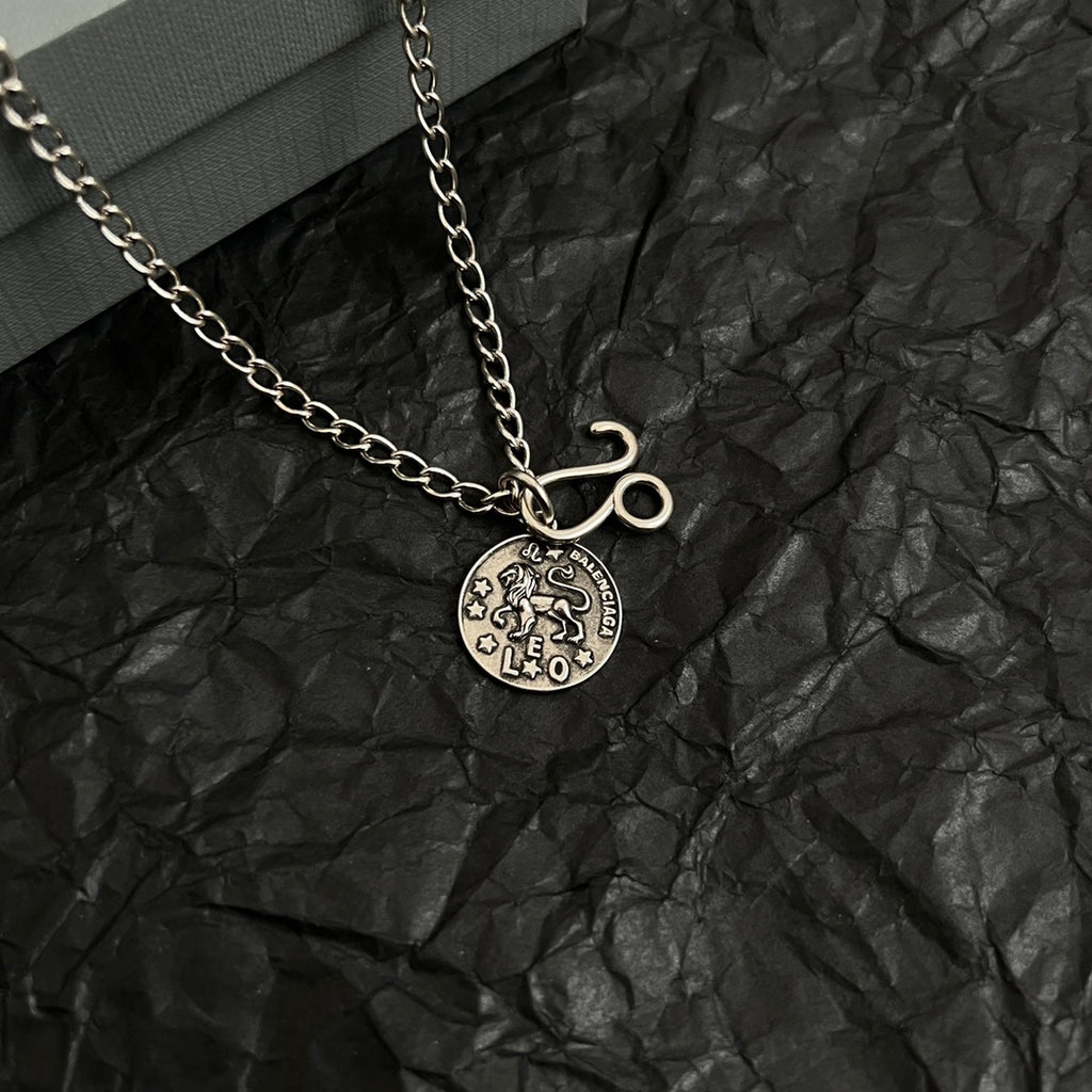 Balenciaga charm necklace with round logo pendant and hook charm on chain